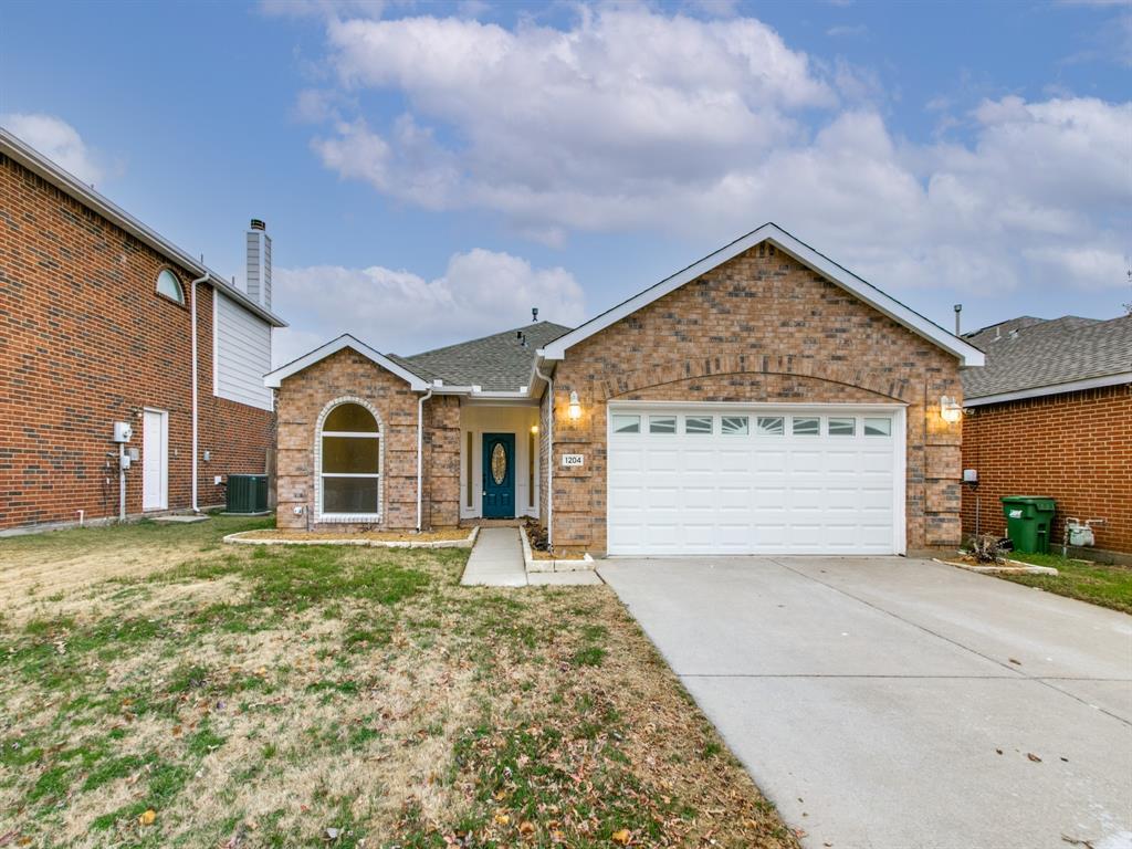 a view of a white house with a yard and garage