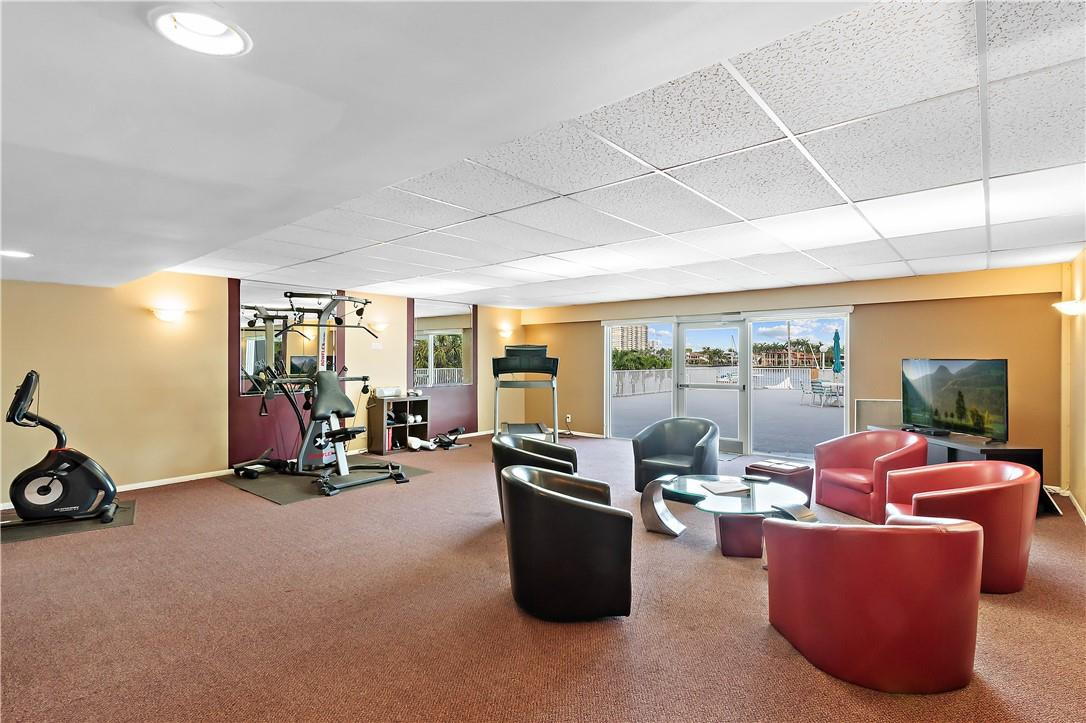 95 North Birch Road, Unit 405 Fort Lauderdale, FL 33304 - Photo 23 of 34 a room with gym equipment and large windows