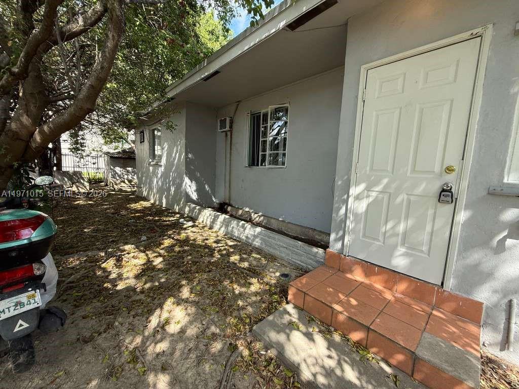 1751 Northwest 29th Street, Unit H Miami, FL 33142 - Photo 2 of 7 a backyard of a house