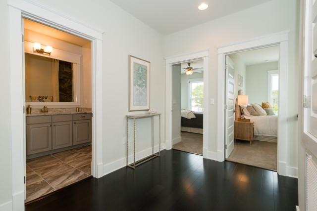16 Clipper Street Inlet Beach, FL 32461 - Photo 11 of 34 a view of a bedroom with wooden floor and a bathroom