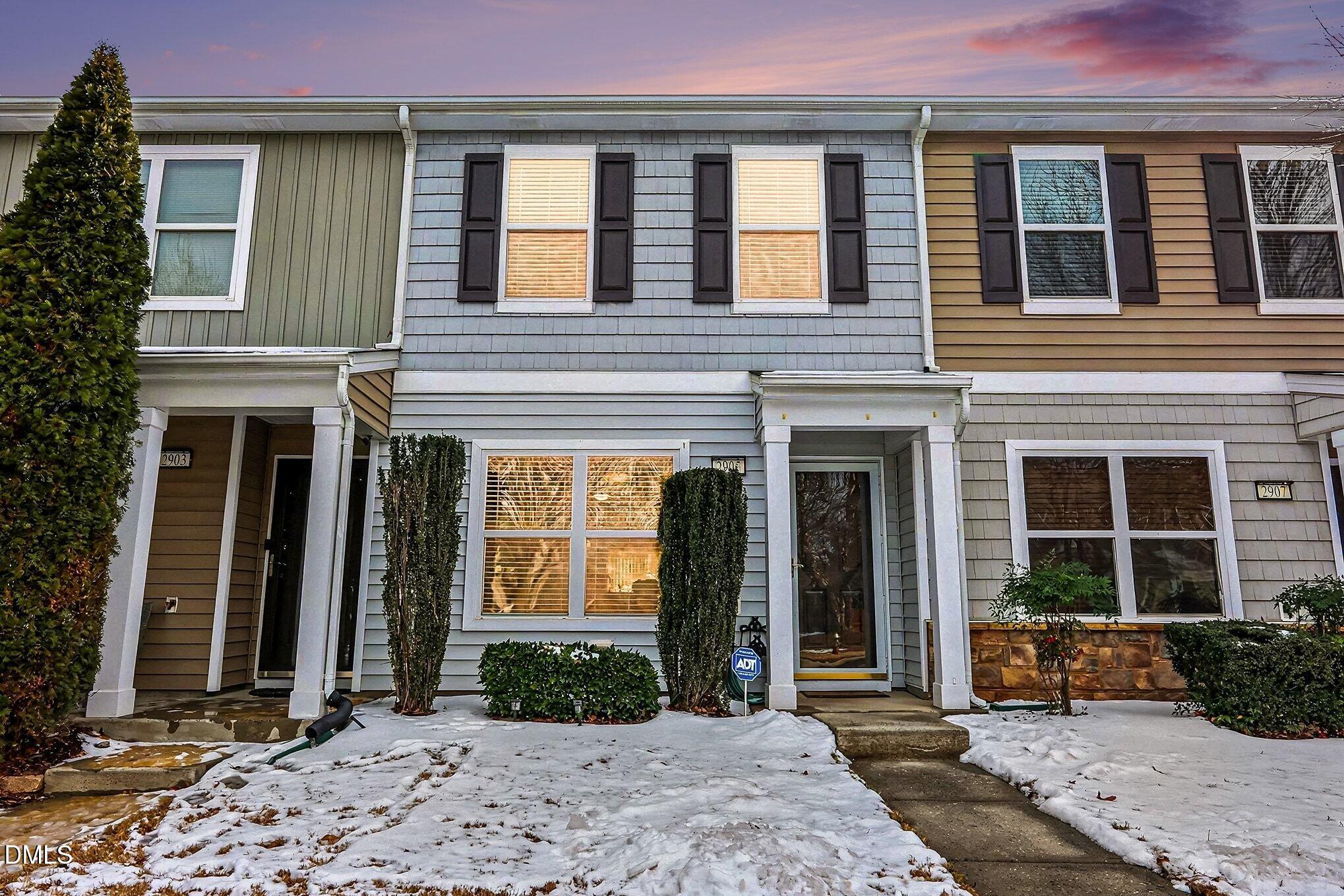 front view of a brick house with a yard