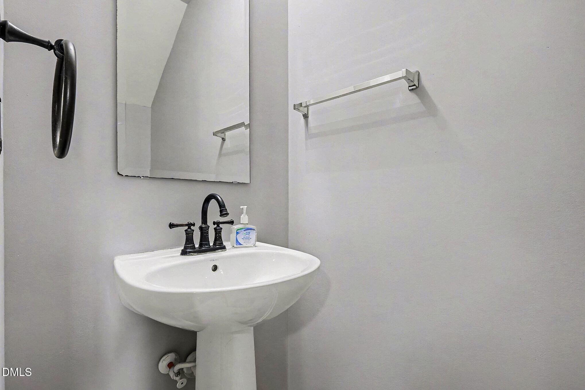 2905 Berkeley Springs Place Raleigh, NC 27616 - Photo 11 of 20 a bathroom with a sink and mirror