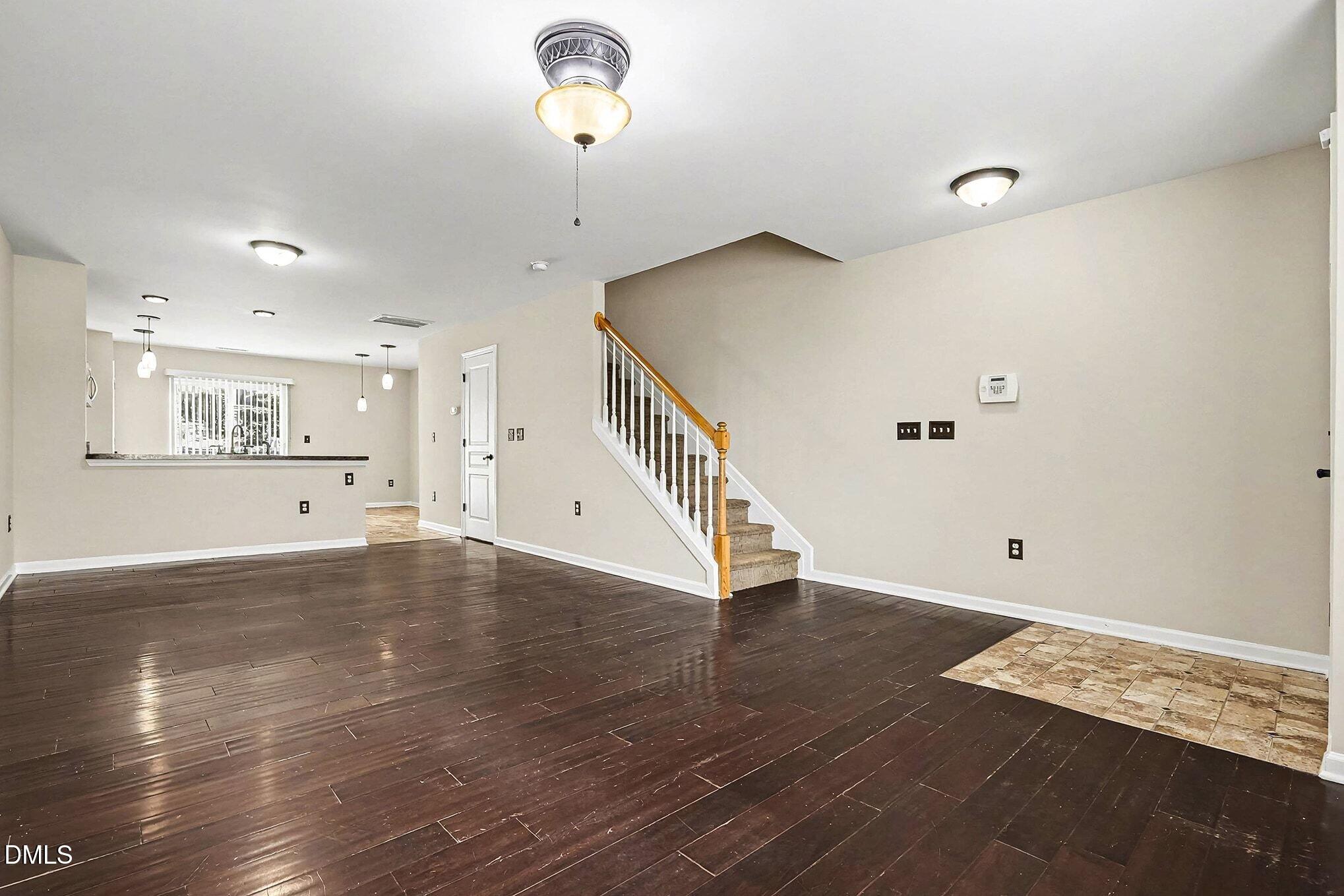 2905 Berkeley Springs Place Raleigh, NC 27616 - Photo 4 of 20 a view of an empty room with wooden floor