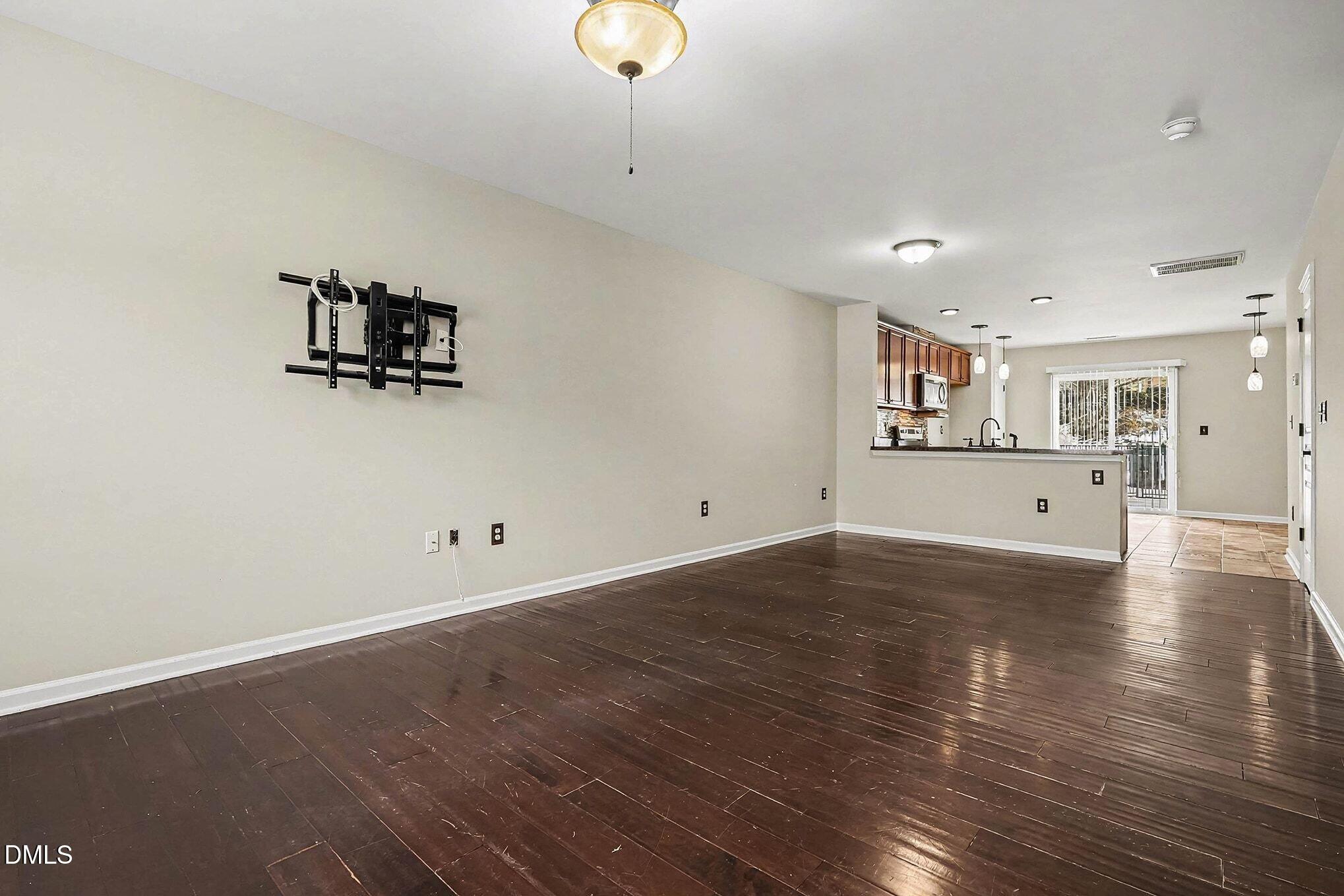 2905 Berkeley Springs Place Raleigh, NC 27616 - Photo 5 of 20 an empty room with wooden floor and windows