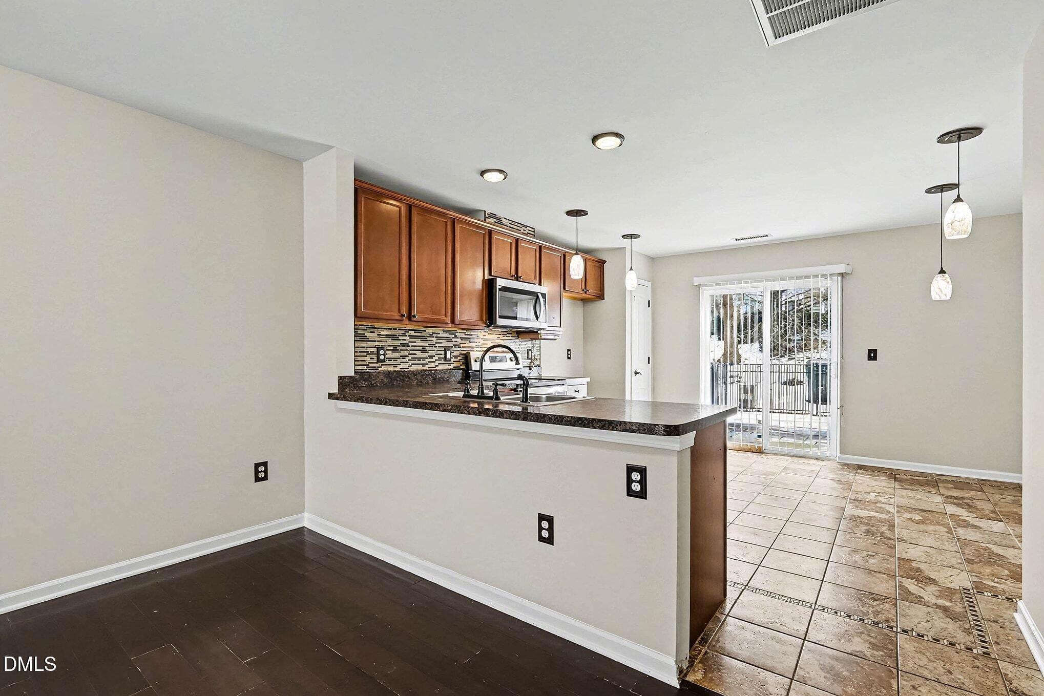 2905 Berkeley Springs Place Raleigh, NC 27616 - Photo 7 of 20 a kitchen with stainless steel appliances granite countertop a sink and cabinets