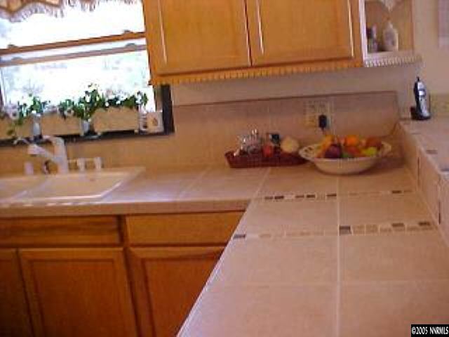 21361 Crestview Road Reno, NV 89521 - Photo 7 of 8 a kitchen with a sink and wooden floor