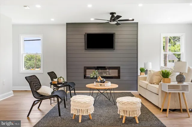 a living room with furniture a fireplace and a flat screen tv