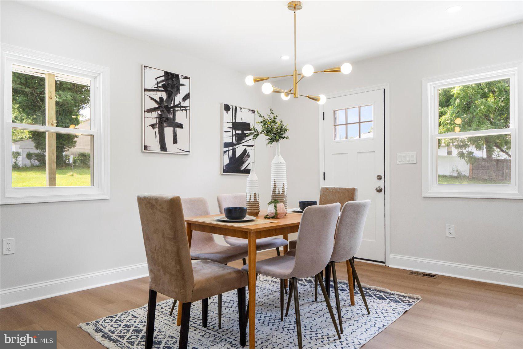 4810 Whitfield Chapel Road Lanham, MD 20706 - Photo 14 of 52 a view of a dining room with furniture wooden floor and a chandelier