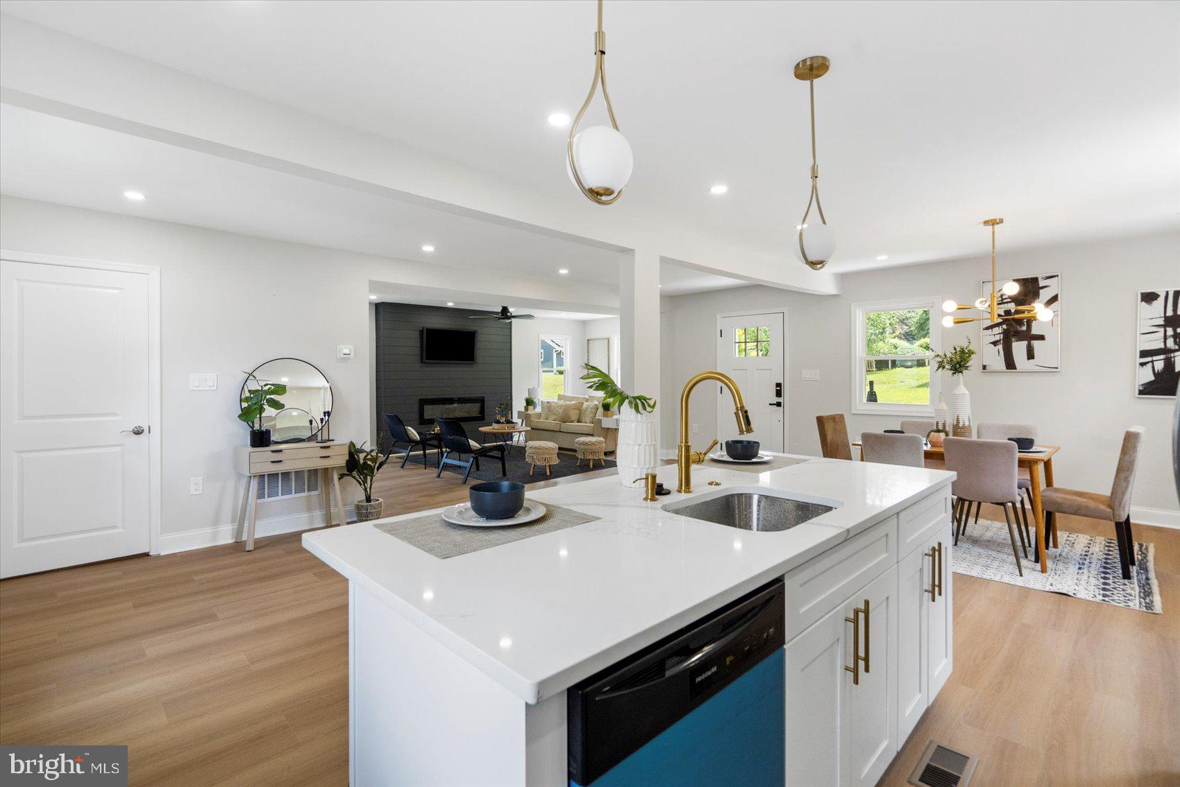 4810 Whitfield Chapel Road Lanham, MD 20706 - Photo 18 of 52 a kitchen with a sink a counter and chairs