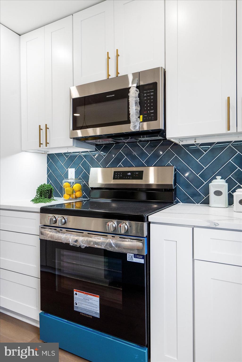 4810 Whitfield Chapel Road Lanham, MD 20706 - Photo 20 of 52 a stove top oven sitting inside of a kitchen