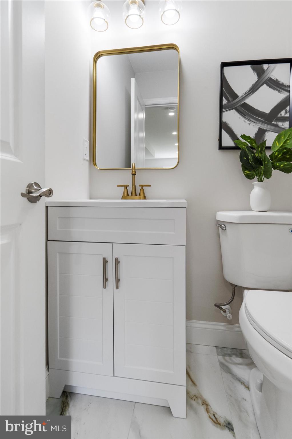 4810 Whitfield Chapel Road Lanham, MD 20706 - Photo 21 of 52 a bathroom with a toilet a sink and mirror