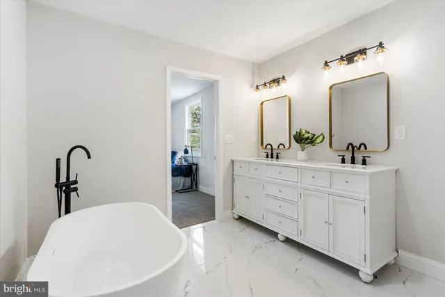 a bathroom with a double vanity sink and a mirror