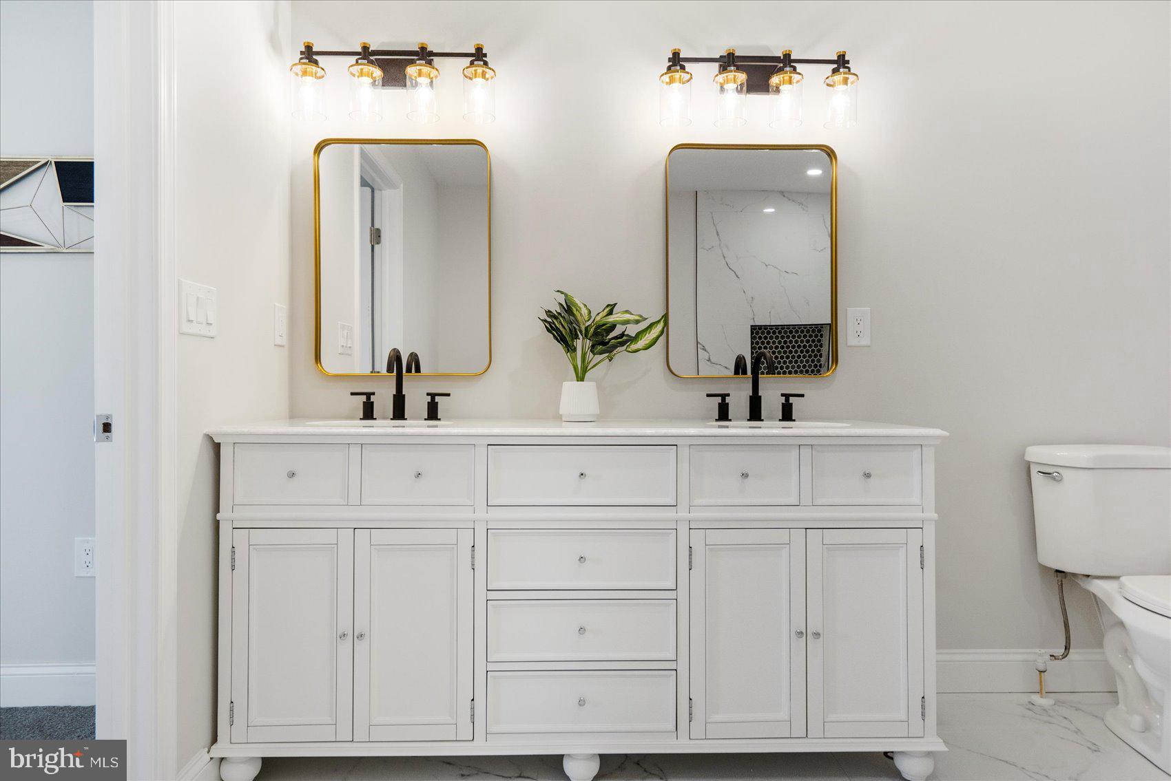 4810 Whitfield Chapel Road Lanham, MD 20706 - Photo 26 of 52 a bathroom with double vanity sinks and a mirror