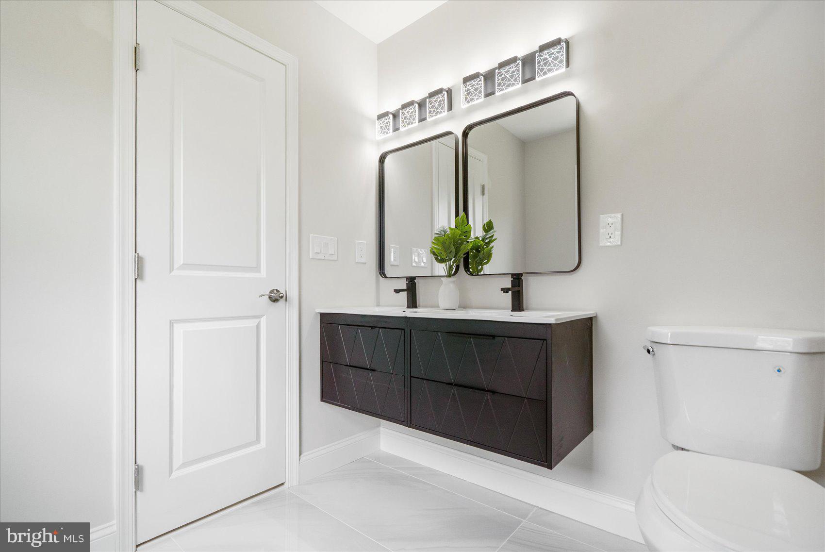 4810 Whitfield Chapel Road Lanham, MD 20706 - Photo 34 of 52 a bathroom with a sink and a mirror