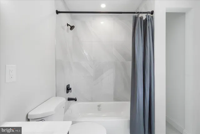 a bathroom with a shower and a bath tub
