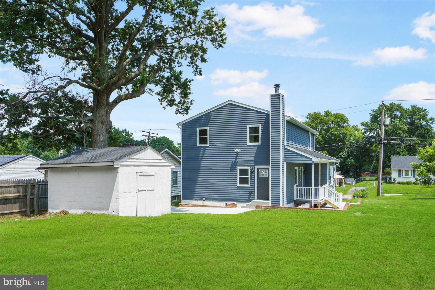 4810 Whitfield Chapel Road Lanham, MD 20706 - Photo 4 of 52 a front view of a house with a garden and yard