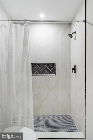 a bathroom with a shower and a sink