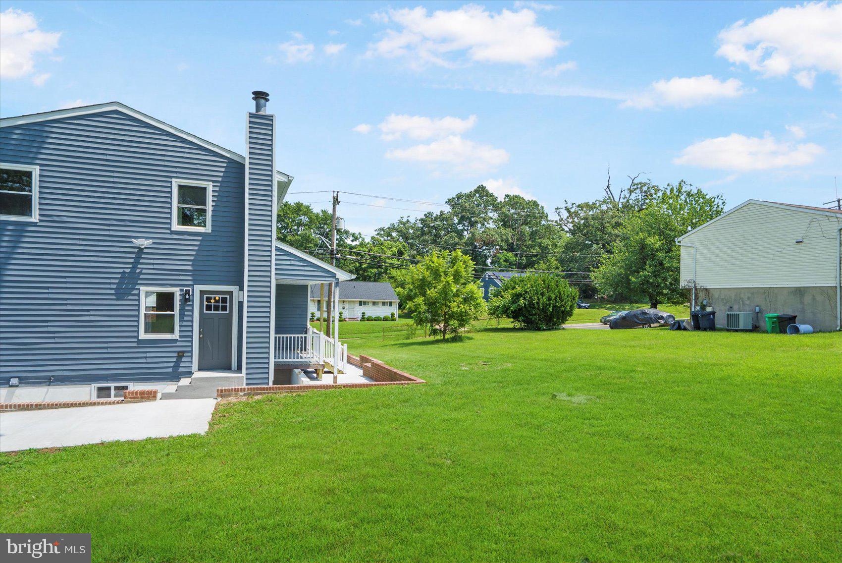 4810 Whitfield Chapel Road Lanham, MD 20706 - Photo 47 of 52 a front view of a house with a yard and green space