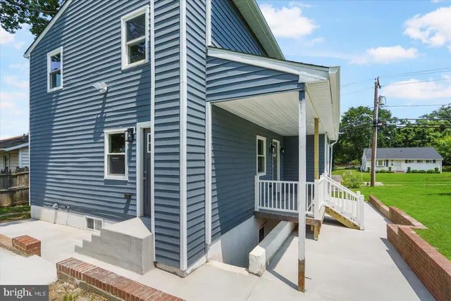 a view of house with a back yard