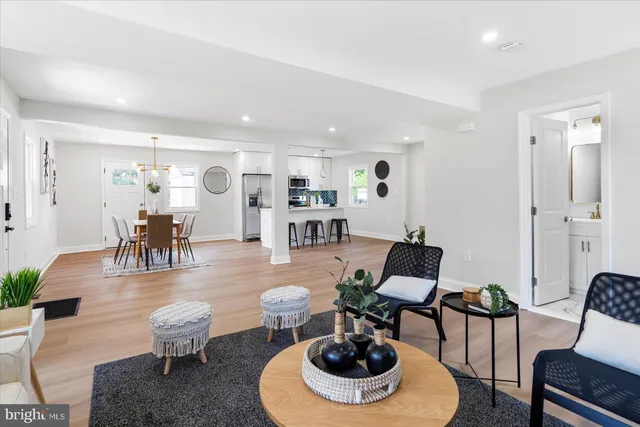 a living room with furniture a table and chairs