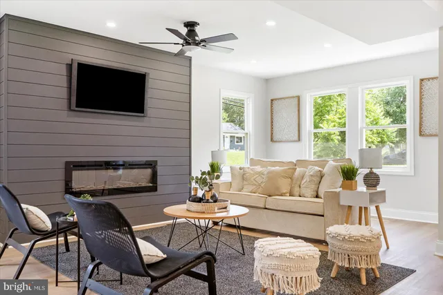 a living room with furniture a flat screen tv and a fireplace