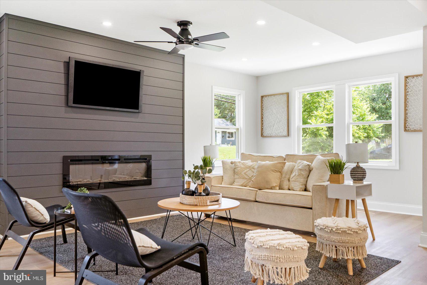 4810 Whitfield Chapel Road Lanham, MD 20706 - Photo 10 of 52 a living room with furniture a flat screen tv and a fireplace