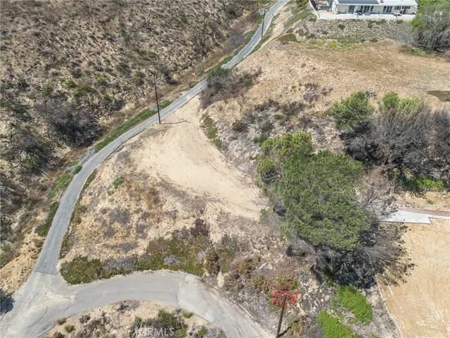 a view of a yard with wooden fence