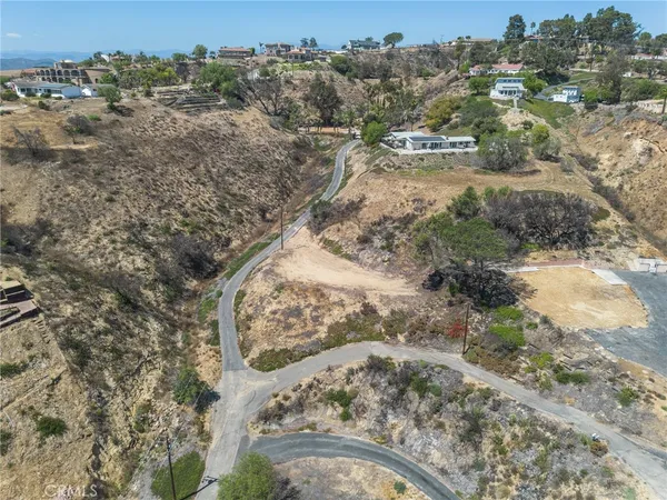 an aerial view of house with yard and mountain view in back