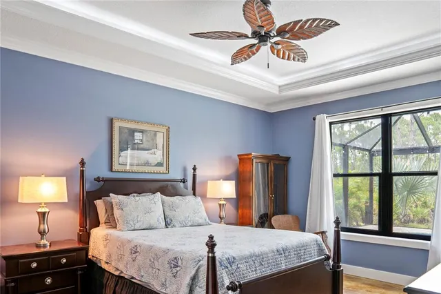 a bedroom with a bed and a chandelier