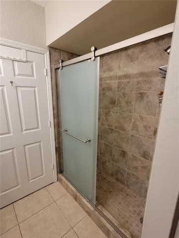 a bathroom with a shower and a glass door