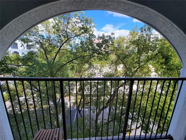 a view of a balcony with wooden fence