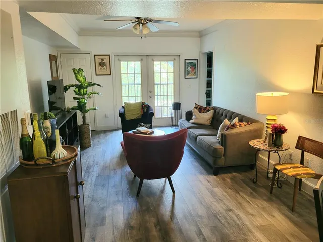 a living room with furniture a lamp and a window