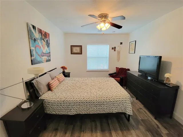 a bedroom with a bed and a chandelier