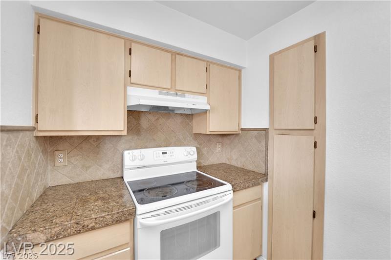 8101 West Flamingo Road, Unit 2030 Las Vegas, NV 89147 - Photo 24 of 27 Functional kitchen with ample cabinetry and a clean electric range for culinary endeavors.