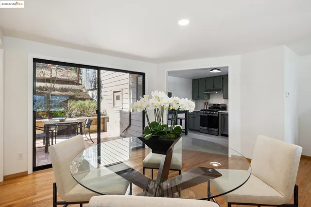 a living room with fireplace furniture dining table and a large window