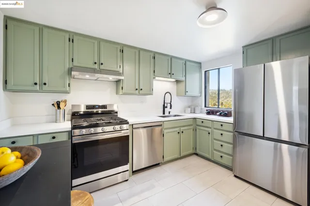 a kitchen with a stove and a refrigerator