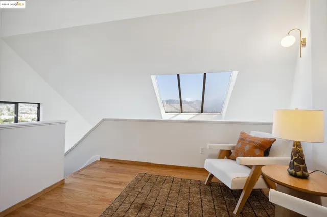 a view of room with furniture and wooden floor