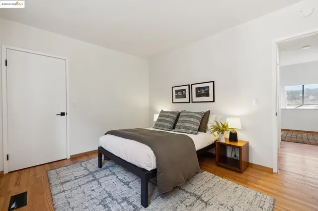 a bed room with a bed and a chair