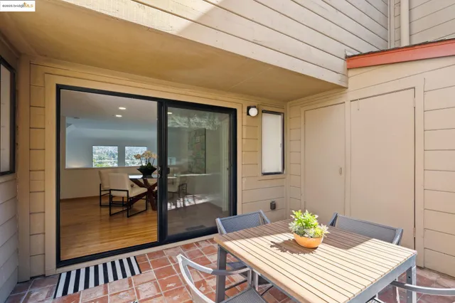 a view of a dining room with a table and chairs