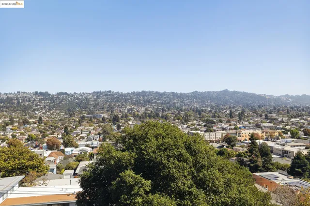 an aerial view of residential houses with city view
