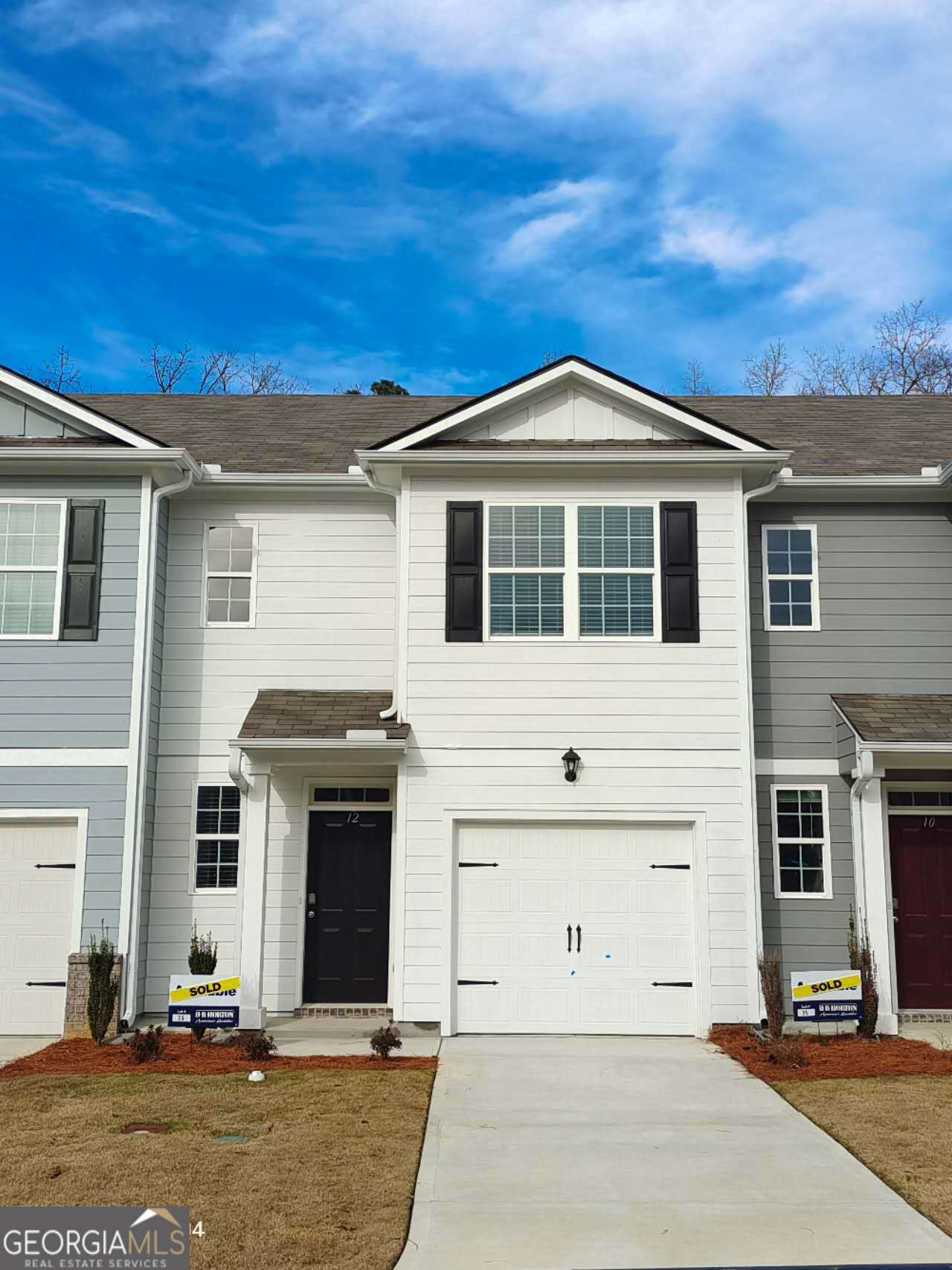 a front view of a house with a garage