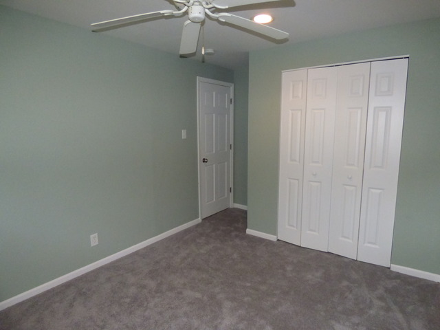 348 East Briarcliff Road Bolingbrook, IL 60440 - Photo 19 of 20 an empty room with a fan & a ceiling fan