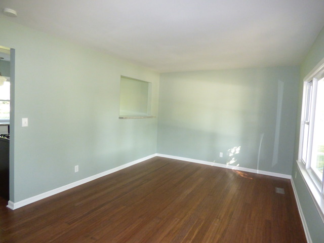 348 East Briarcliff Road Bolingbrook, IL 60440 - Photo 7 of 20 an empty room with wooden floor and windows