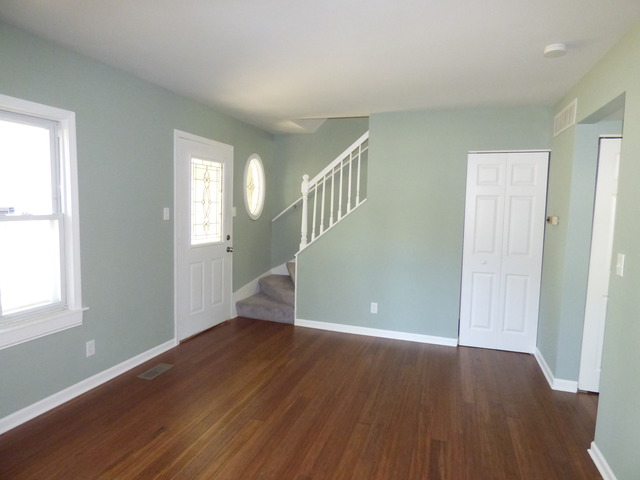 348 East Briarcliff Road Bolingbrook, IL 60440 - Photo 8 of 20 an empty room with wooden floor and windows