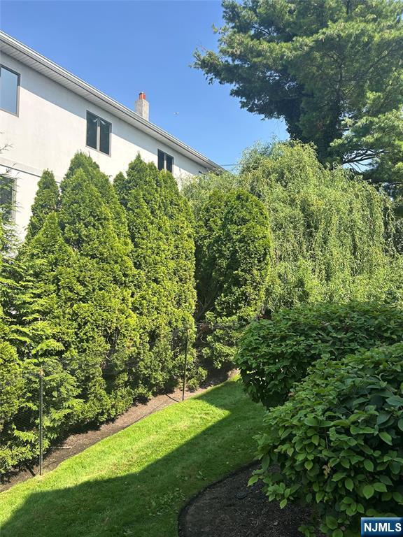 302 Grand Ridge Drive, Unit 302 Ridgefield, NJ 07657 - Photo 11 of 41 a view of a back yard of the house