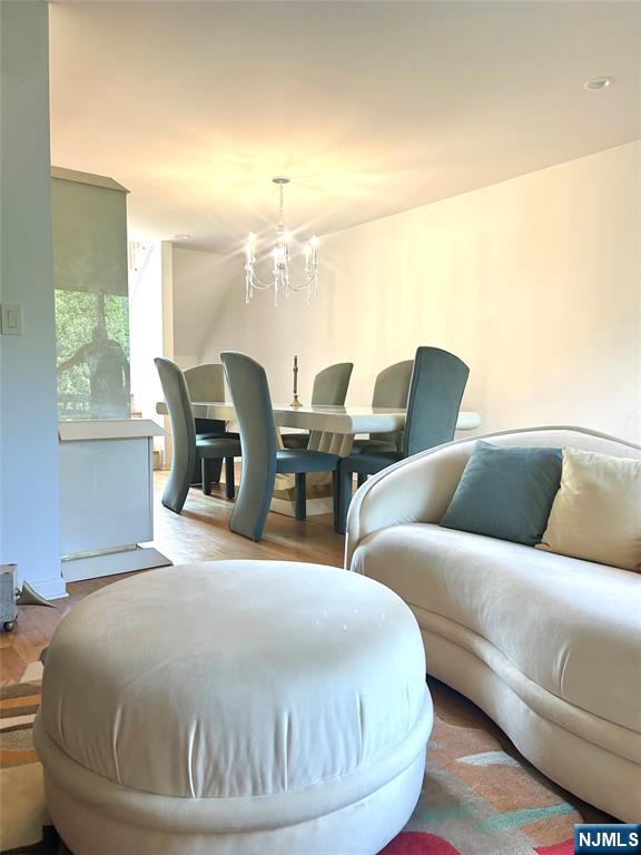 302 Grand Ridge Drive, Unit 302 Ridgefield, NJ 07657 - Photo 13 of 41 a living room with couches chairs and chandelier
