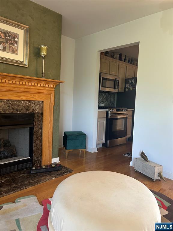 302 Grand Ridge Drive, Unit 302 Ridgefield, NJ 07657 - Photo 14 of 41 a bedroom with a bed and a fireplace