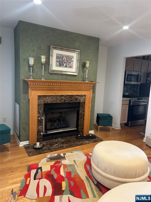 302 Grand Ridge Drive, Unit 302 Ridgefield, NJ 07657 - Photo 15 of 41 a living room with furniture and a fireplace