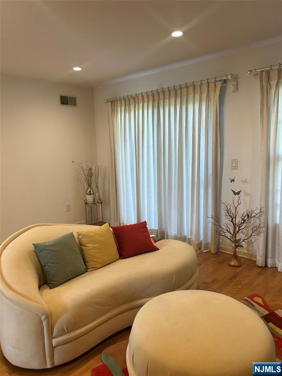 302 Grand Ridge Drive, Unit 302 Ridgefield, NJ 07657 - Photo 16 of 41 a blue couch sitting in a room next to a window