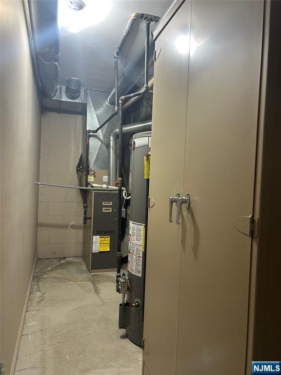 302 Grand Ridge Drive, Unit 302 Ridgefield, NJ 07657 - Photo 2 of 41 a room with water heater and wooden cabinets